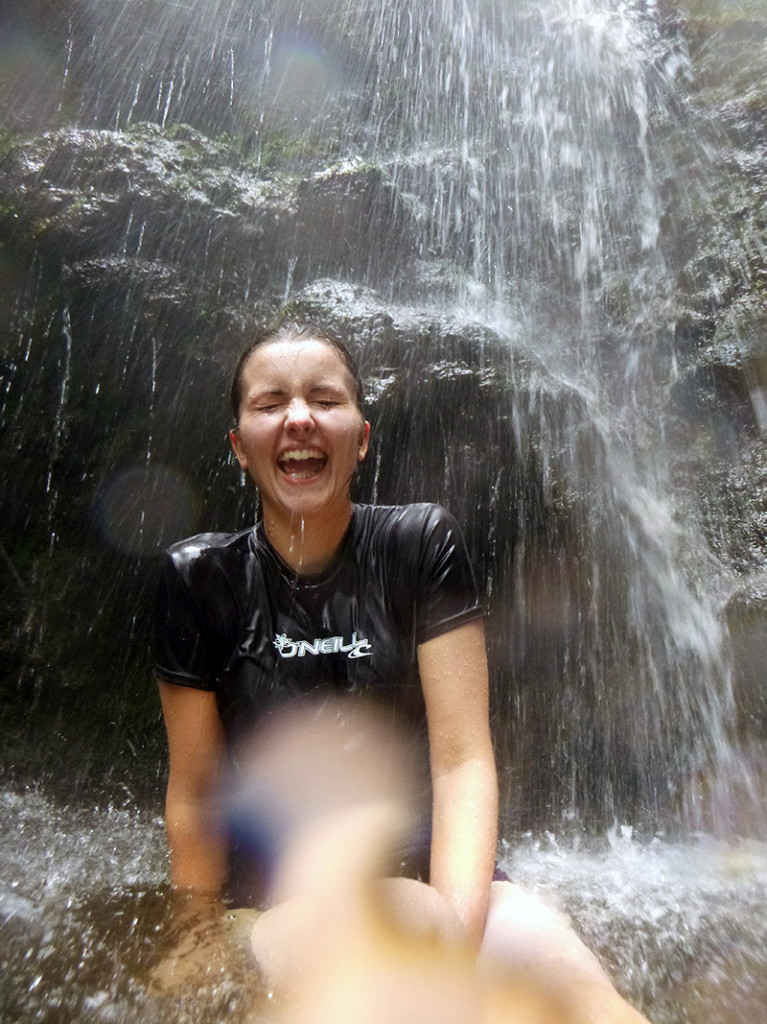 Photo of Ava under a waterfall on Maui